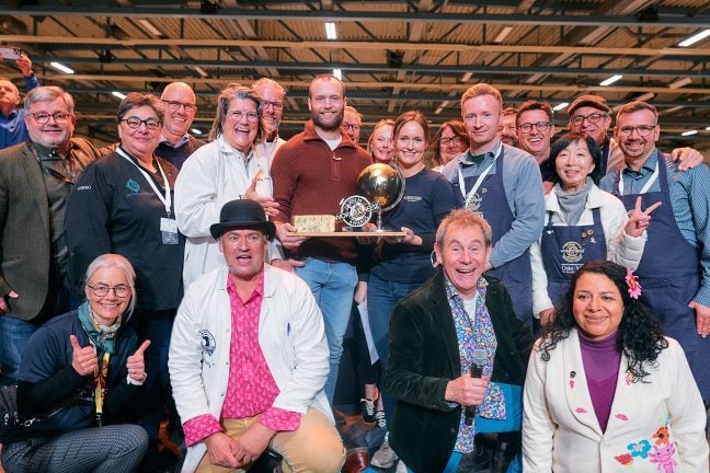 World Cheese Awards 2023, Hosts Nigel Barden and Charlie Turnbull with Super jury judges and Ole and Maren Gangstad, the owners of Gangstad Gårdsysteri holding the World Champion Cheese, Nidelven Blå
