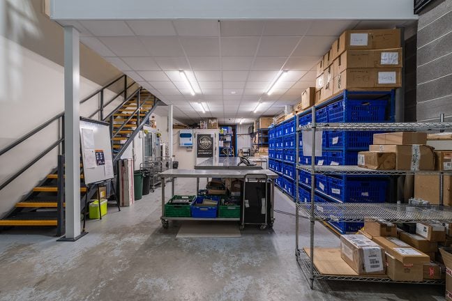 The warehouse, which is adjacent to the training room, features a roller shutter door for access, ample chiller and freezer space, and storge.